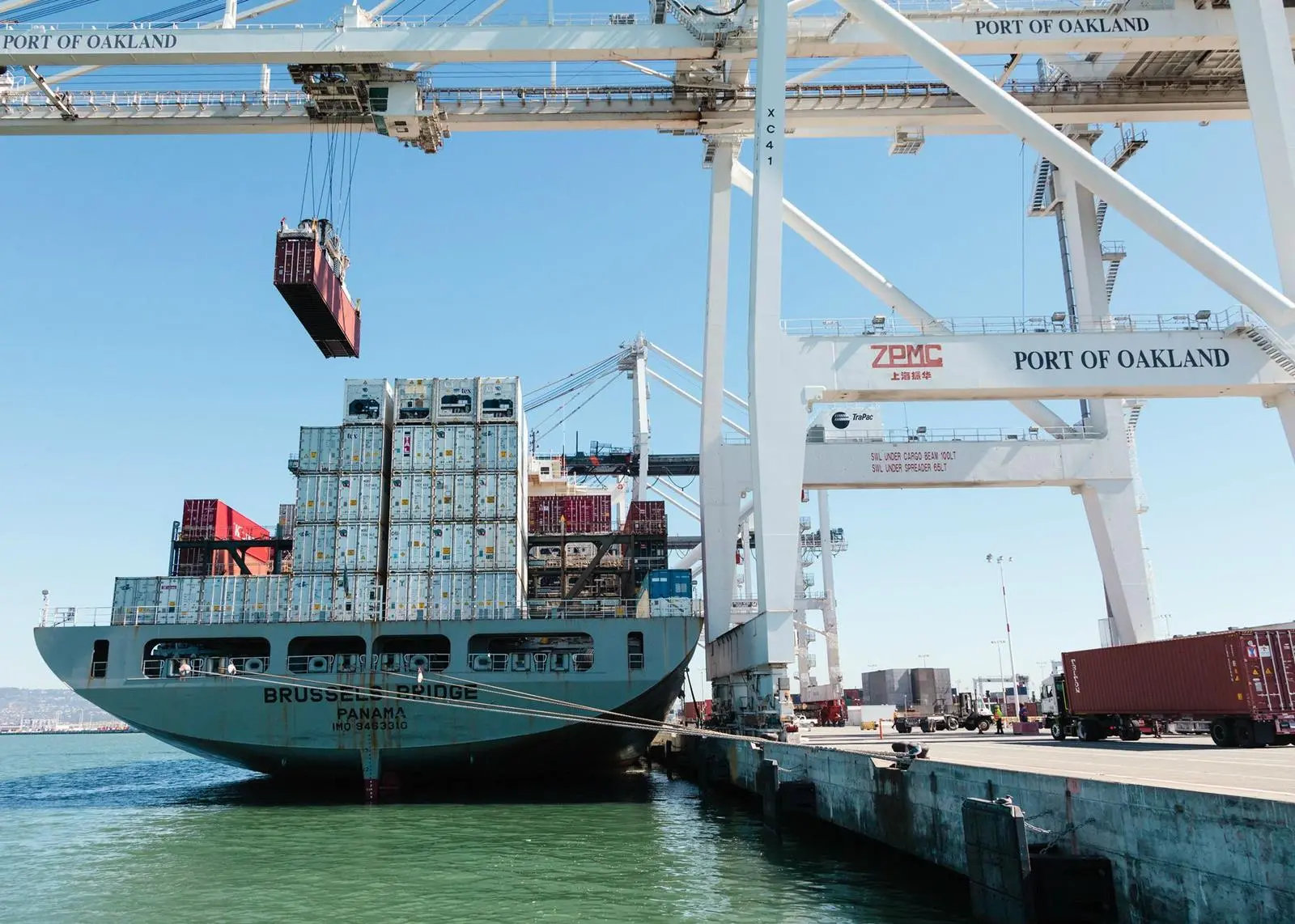 A large containership navigating a port's turning basin.