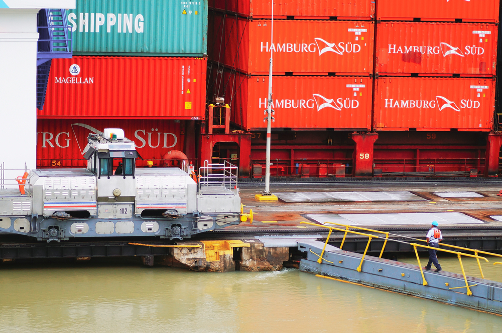 A large Neopanamax container ship transiting through the Panama Canal.