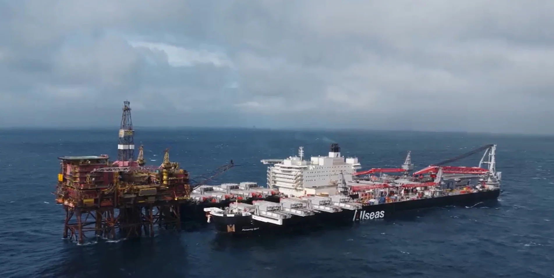 A large offshore platform being lifted by a heavy-lift vessel.