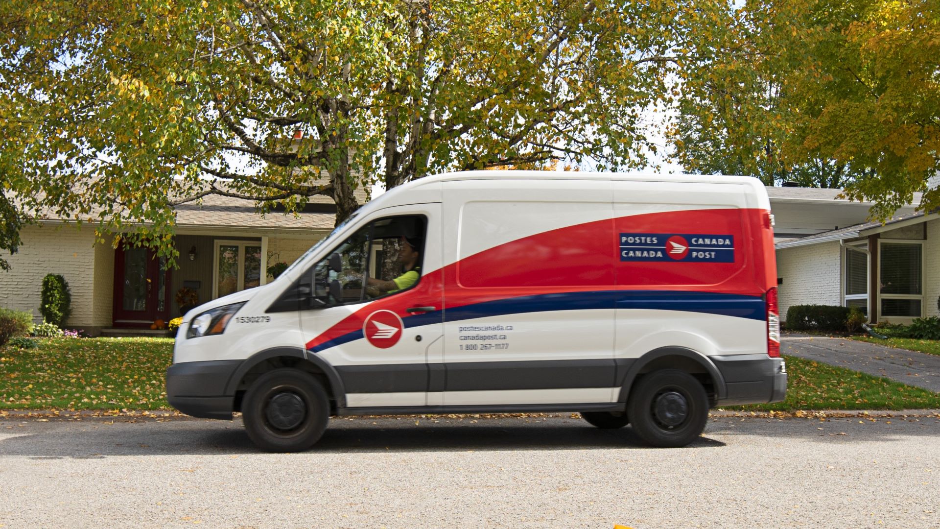 A Canada Post delivery truck on a street, symbolizing parcel logistics.