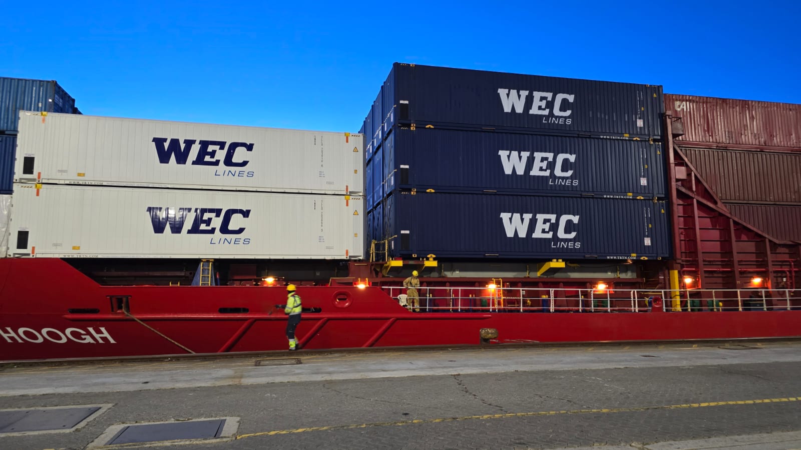Container ship at port with containers stacked