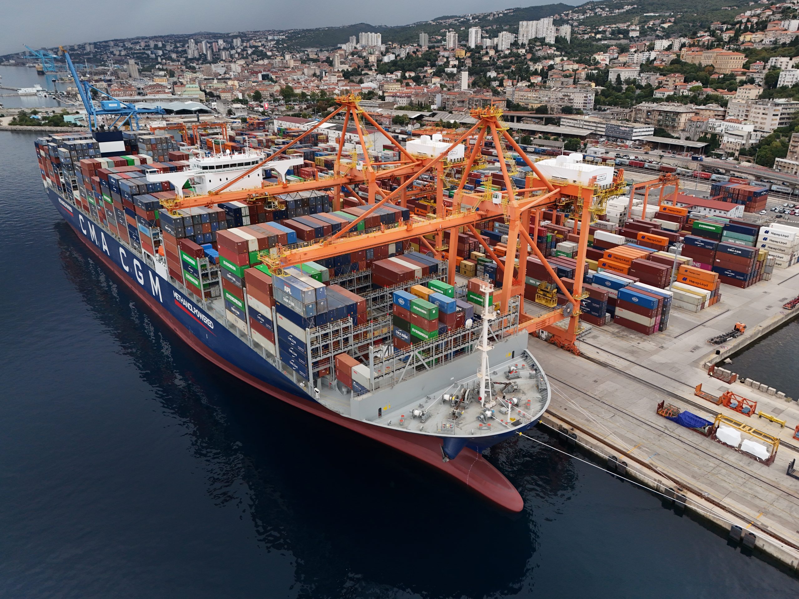 Container ship at a port terminal with cranes