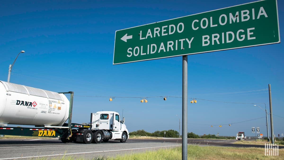 Freight trucks crossing a border checkpoint between Texas and Mexico