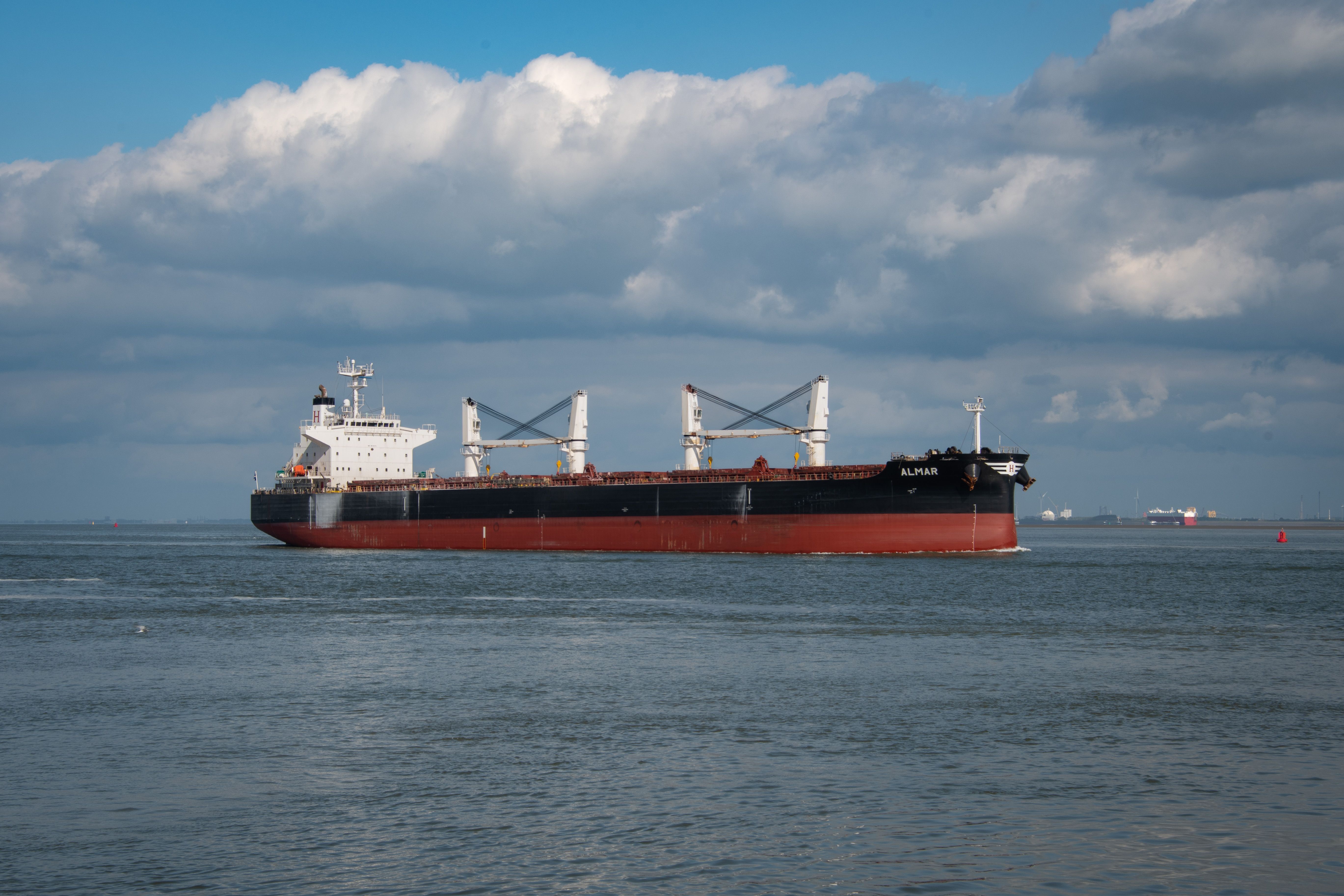 A large bulk carrier vessel navigating open waters, symbolizing maritime logistics and freight transport.