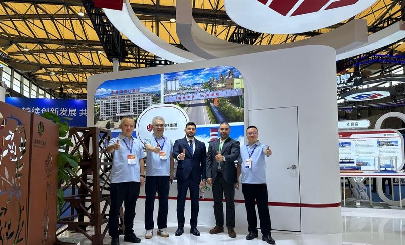 Exhibition hall with attendees at a trade show focused on metallurgy and steel.
